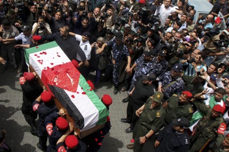 Palestinian Hamas security personnel carry the coffin of Italian activist Vittorio Arrigoni, 36, during a symbolic military funeral in Gaza City, Monday.